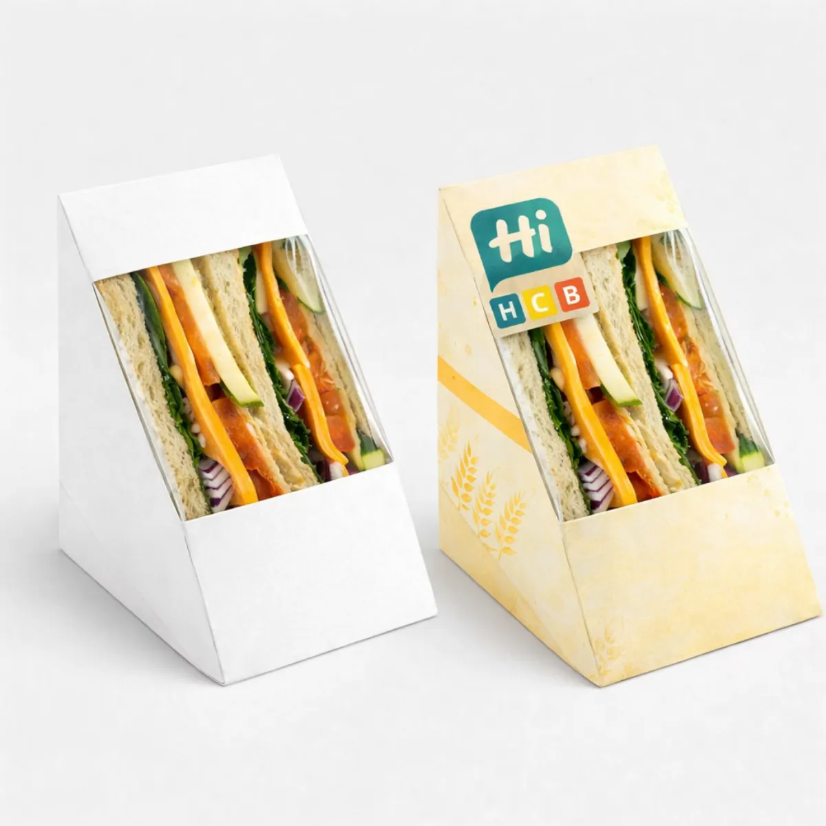 Distinctive triangle-shaped cardboard boxes designed to hold and display halved tortilla wraps or sandwiches securely- class=